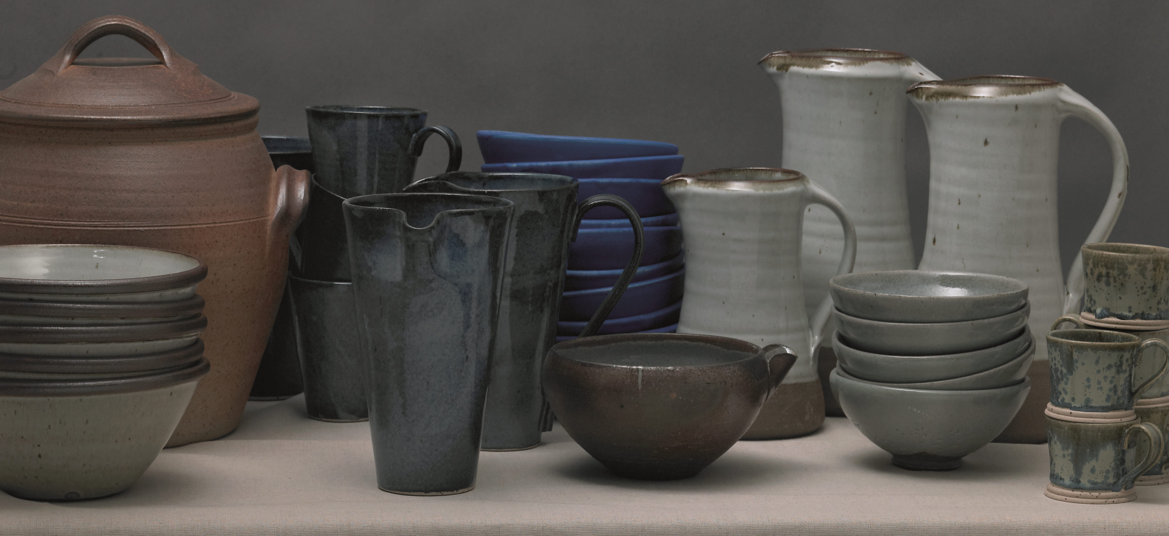 Craft pottery items dispalyed on a table.