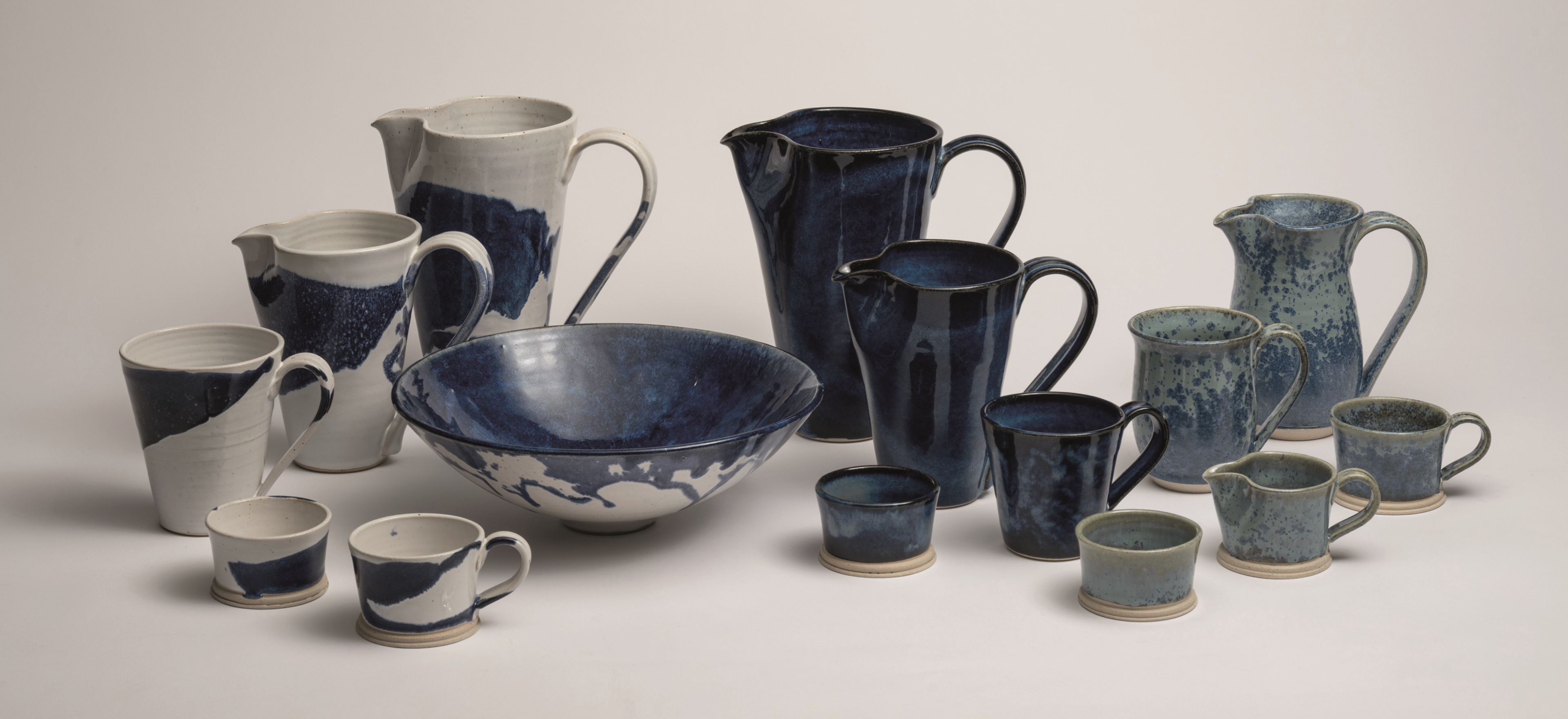 Michael Taylor pottery on a grey background.
