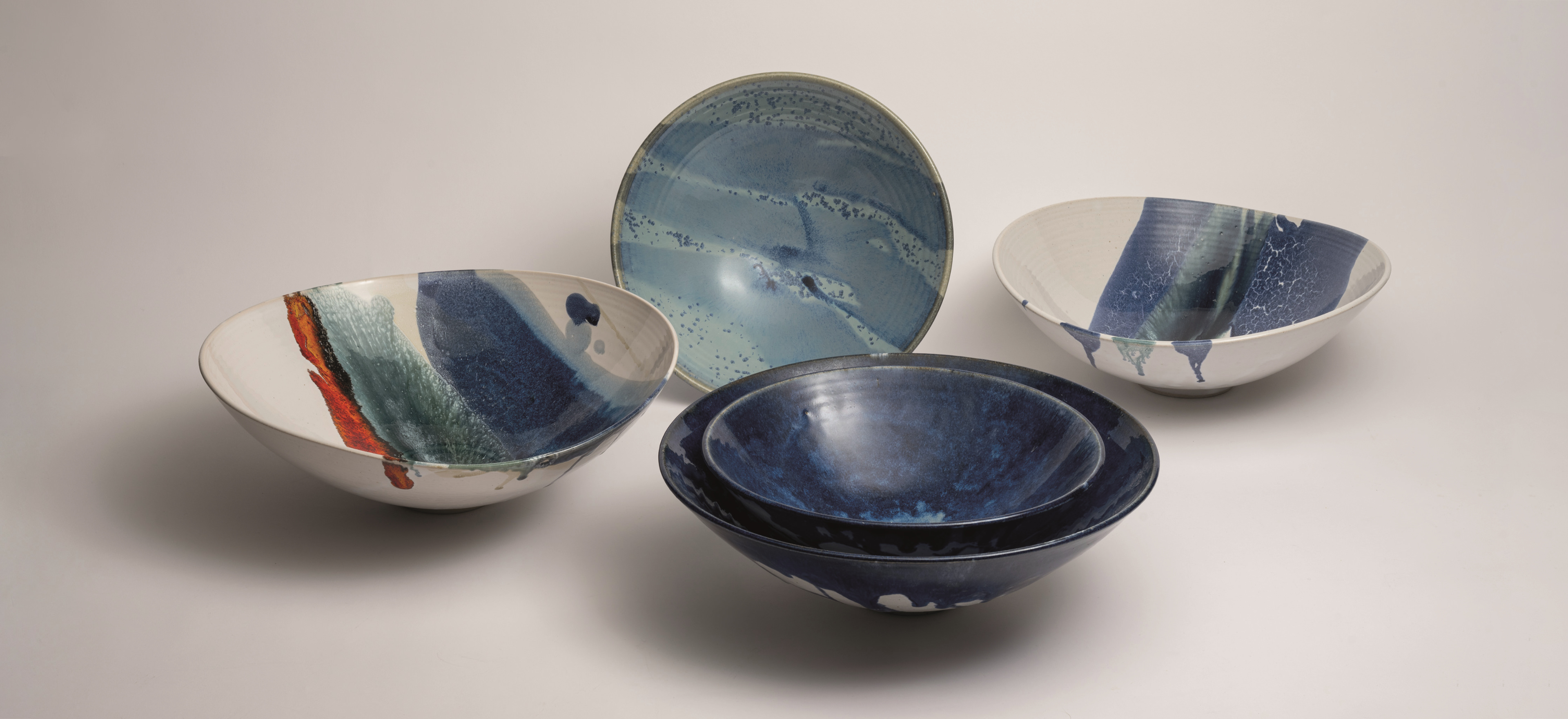 Michael Taylor bowls on a grey background.