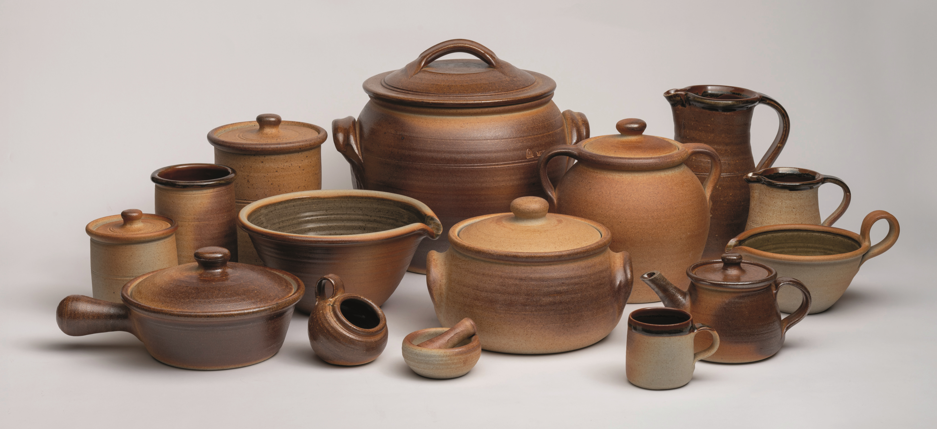 John Leach’s Muchelney pottery on a grey background.