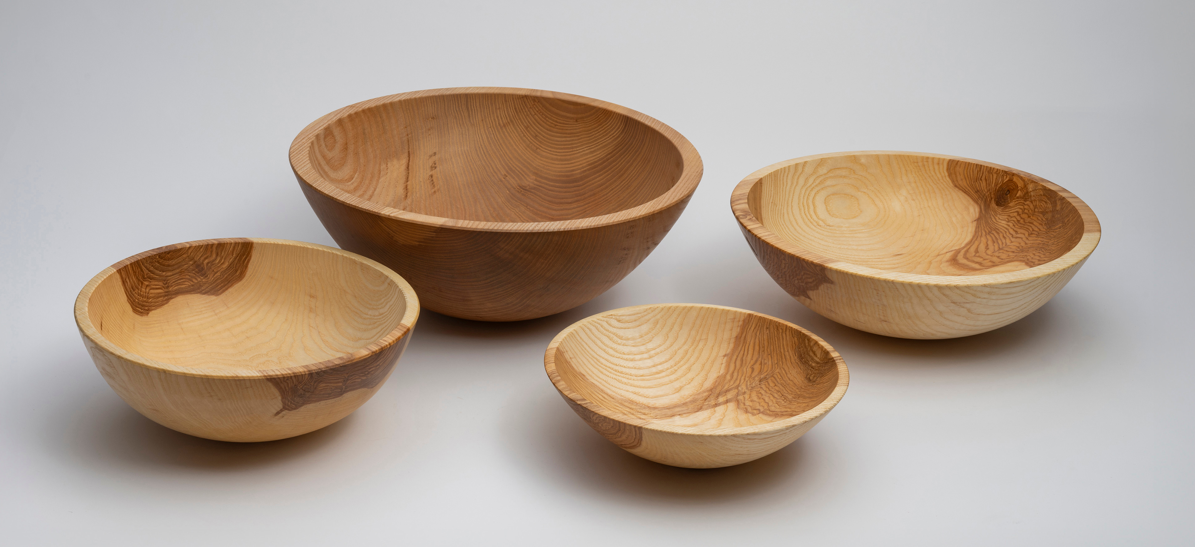 Jamie Lovekin wooden bowls on a grey background.