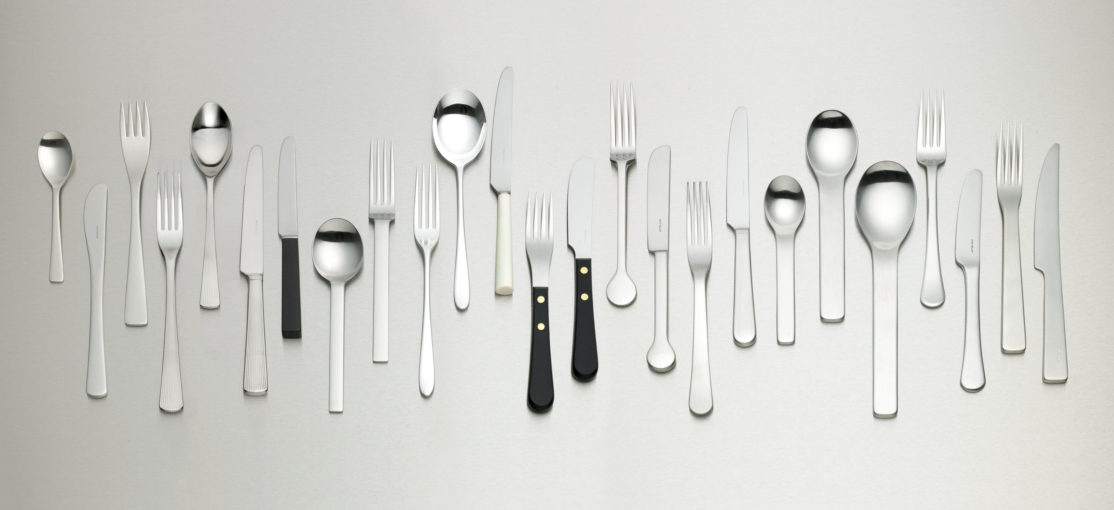 David Mellor stainless steel cutlery ranges arranged on a light grey background.