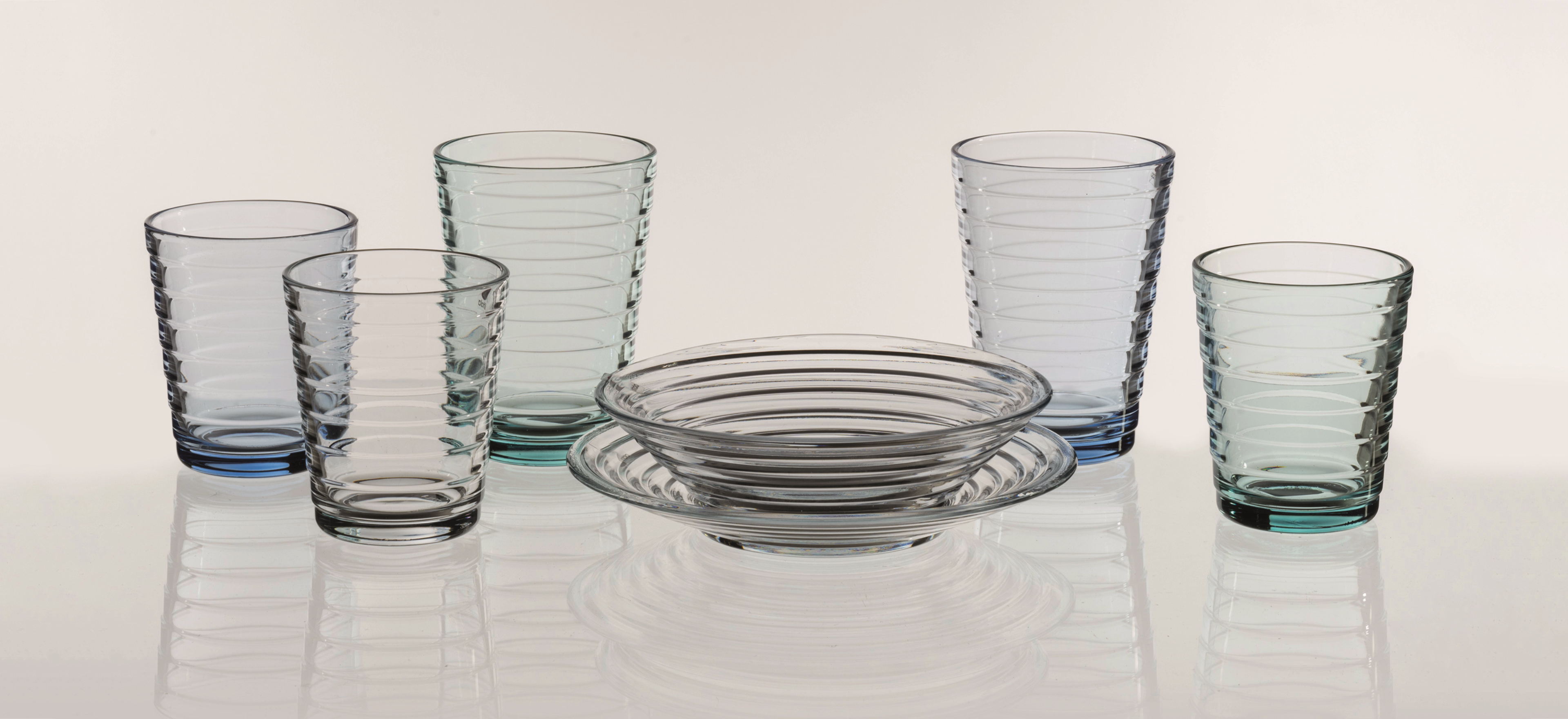 Iittala Aino Aalto glassware on grey background.