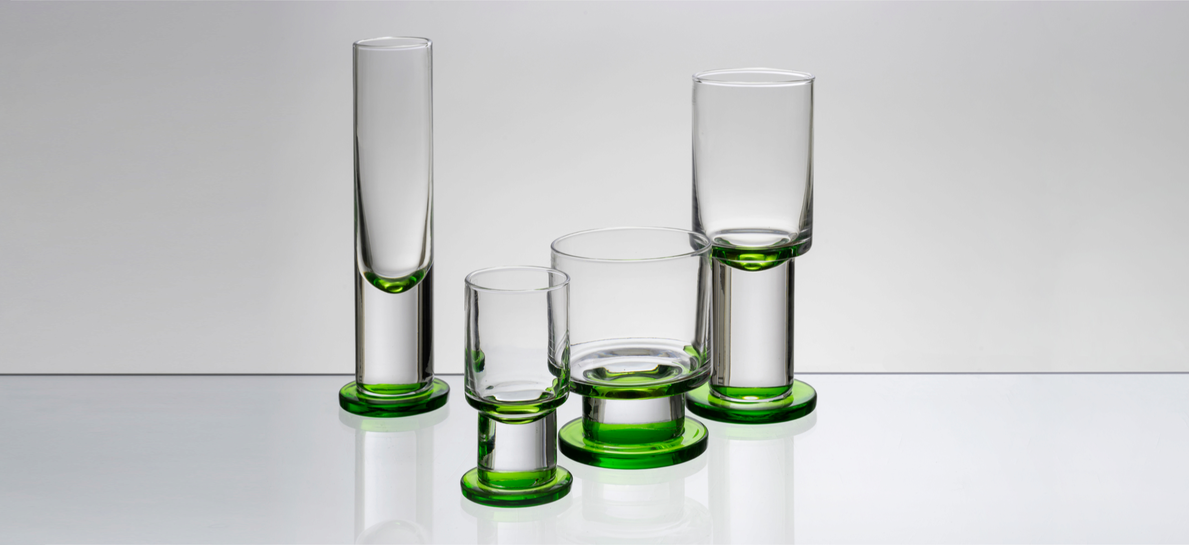 David Mellor column glassware on a grey background.