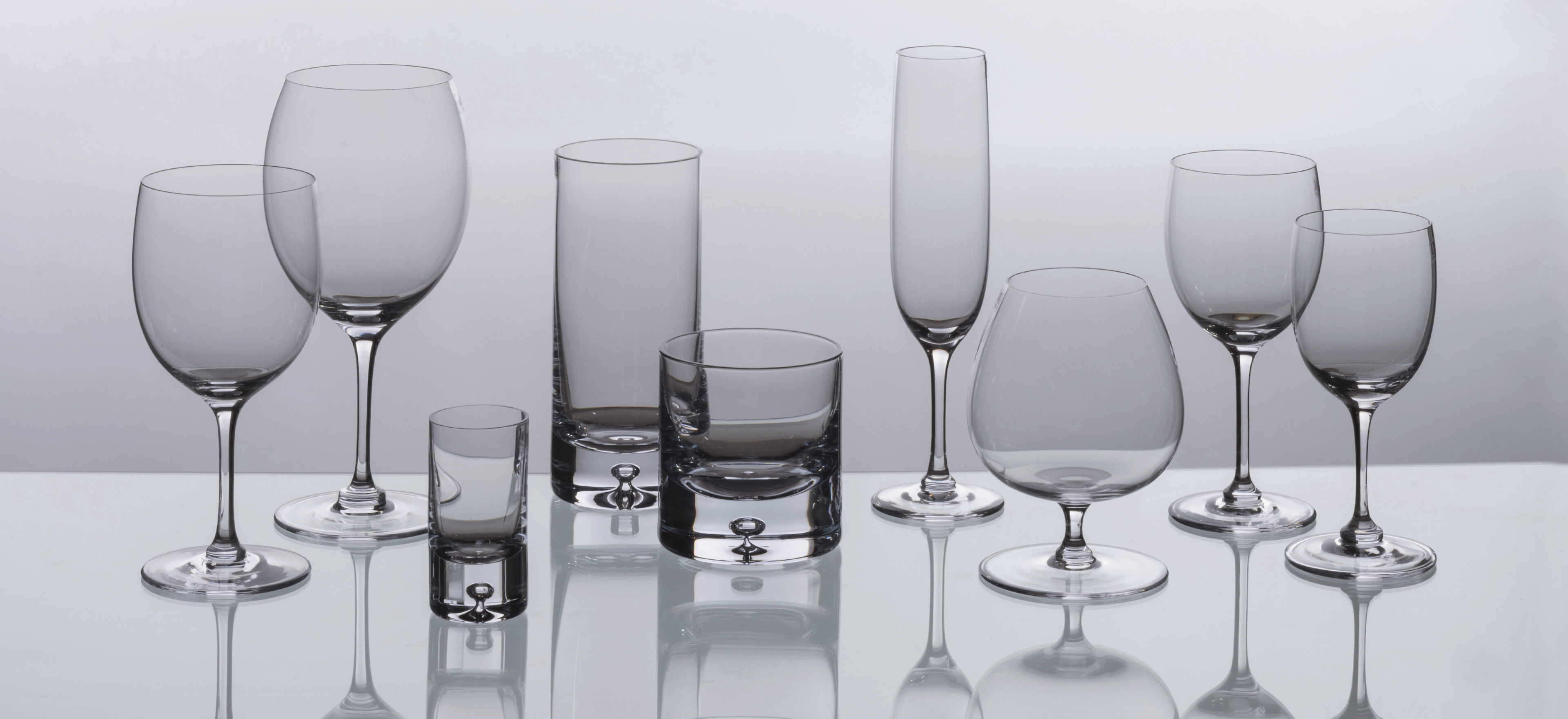David Mellor Connoisseur glassware on a grey background.