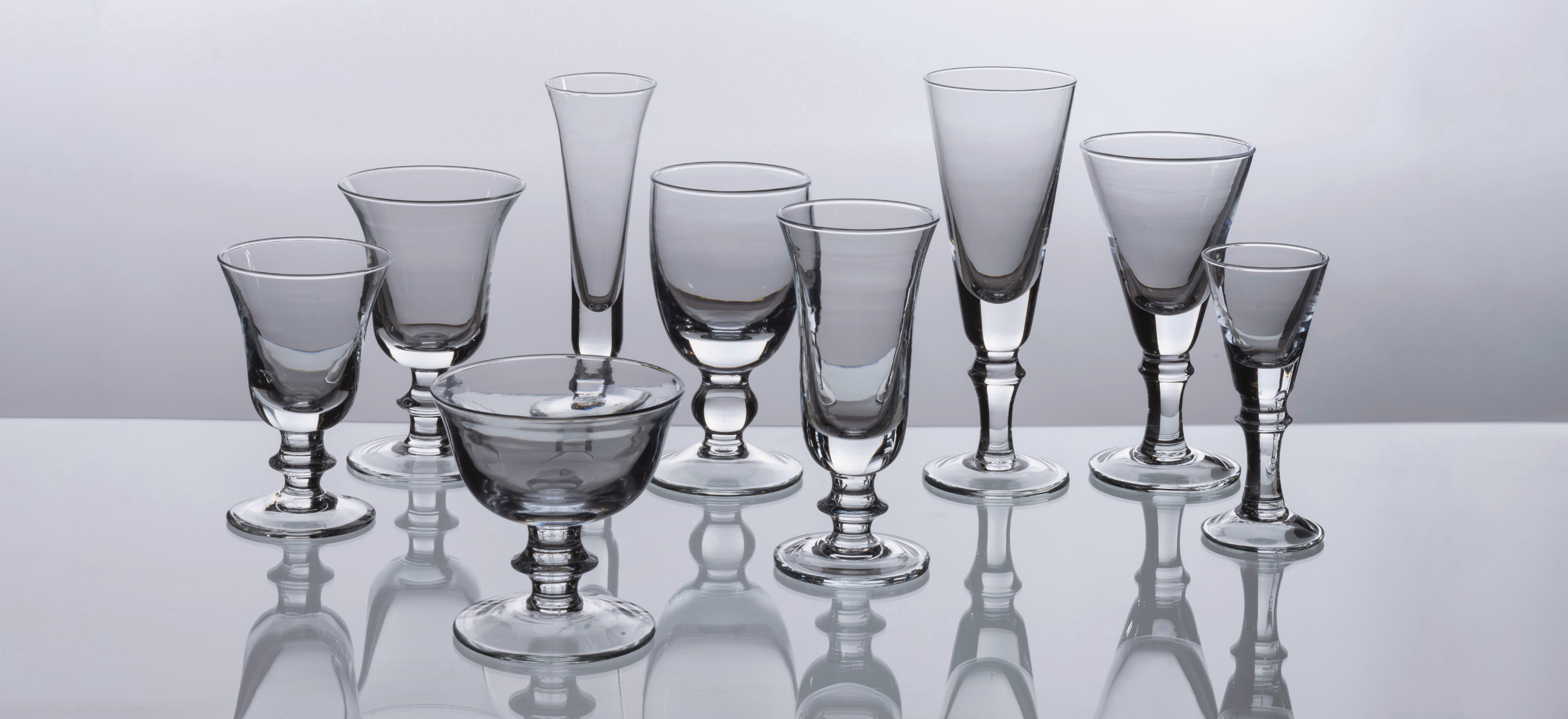 Cristalma glassware on a grey background.