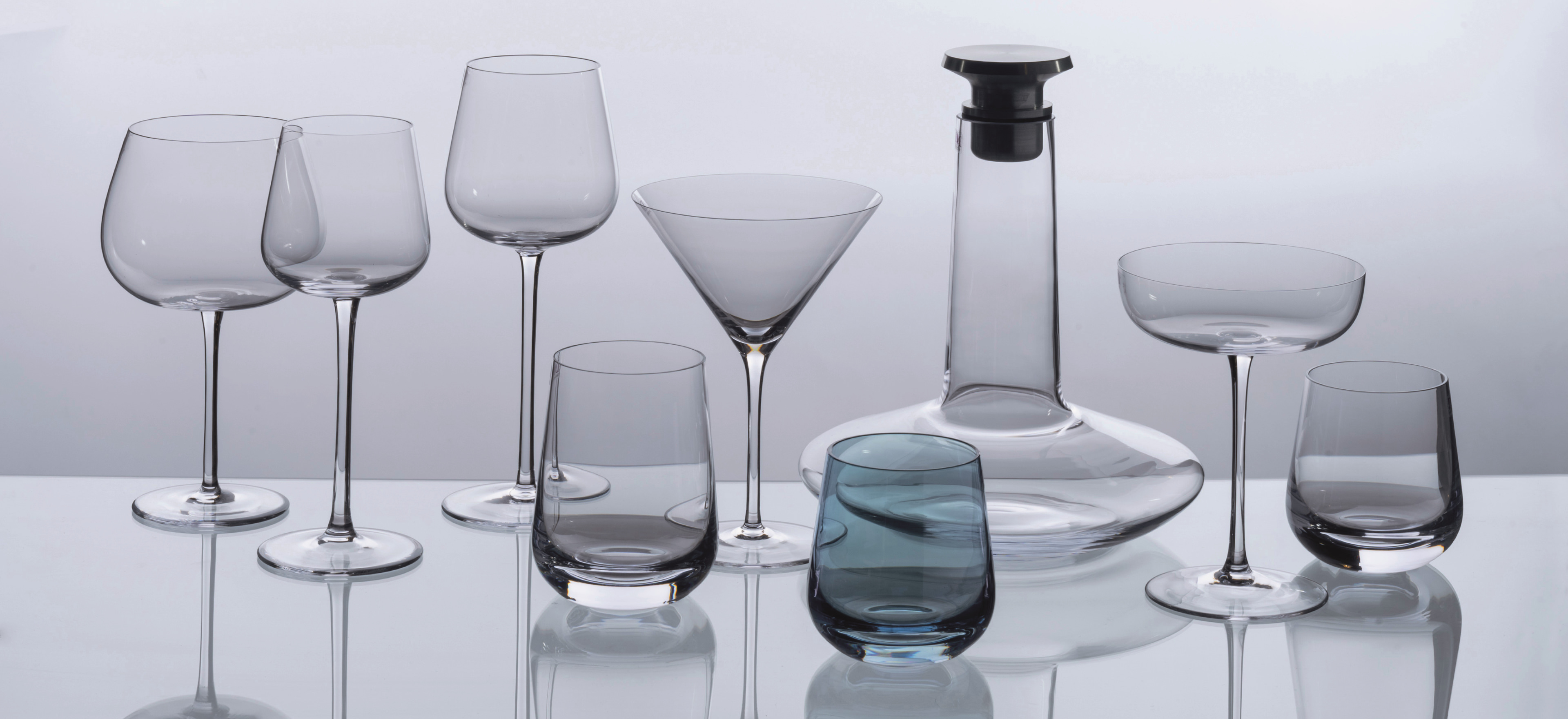 David Mellor Embassy glassware on a grey background.