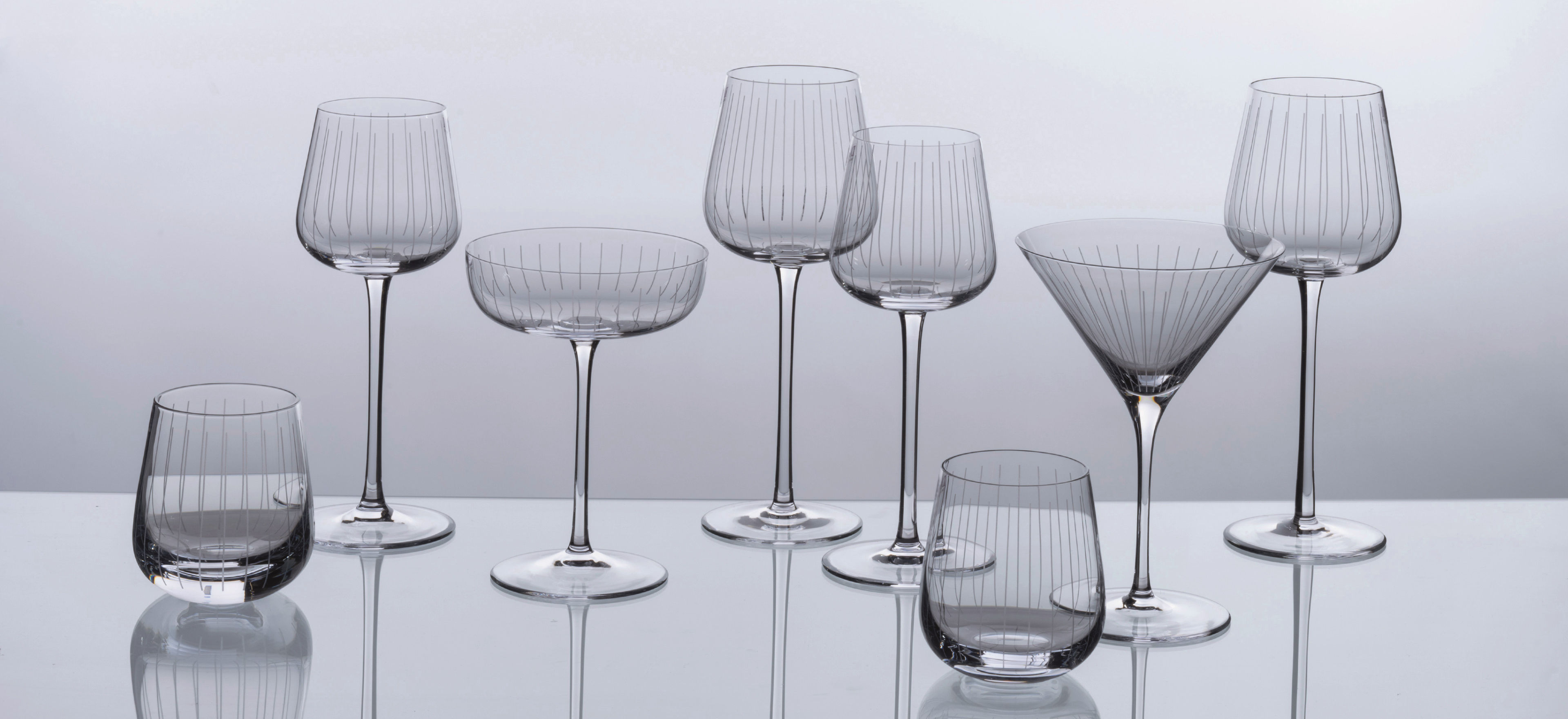 David Mellor Flute glassware on a grey background.