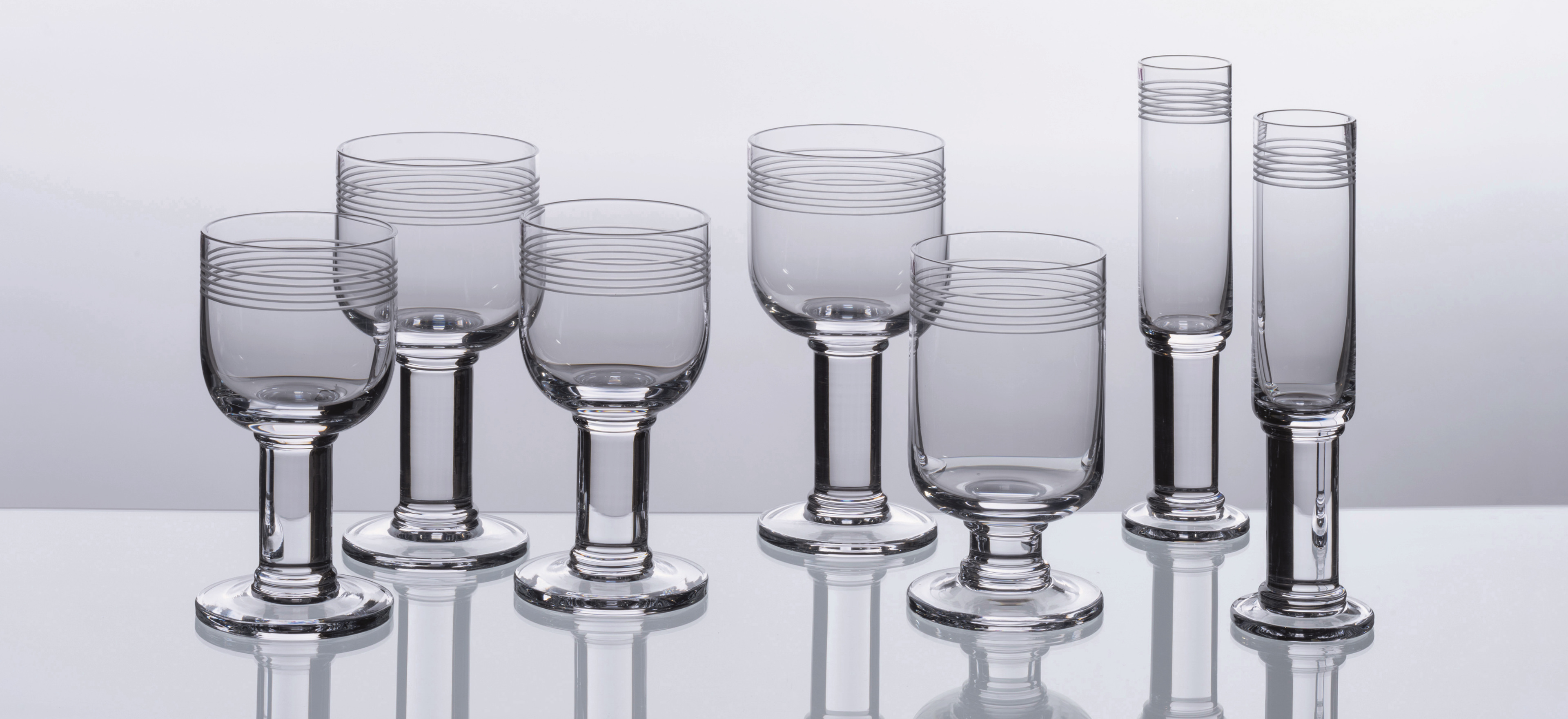 David Mellor Linear glassware on a grey background.