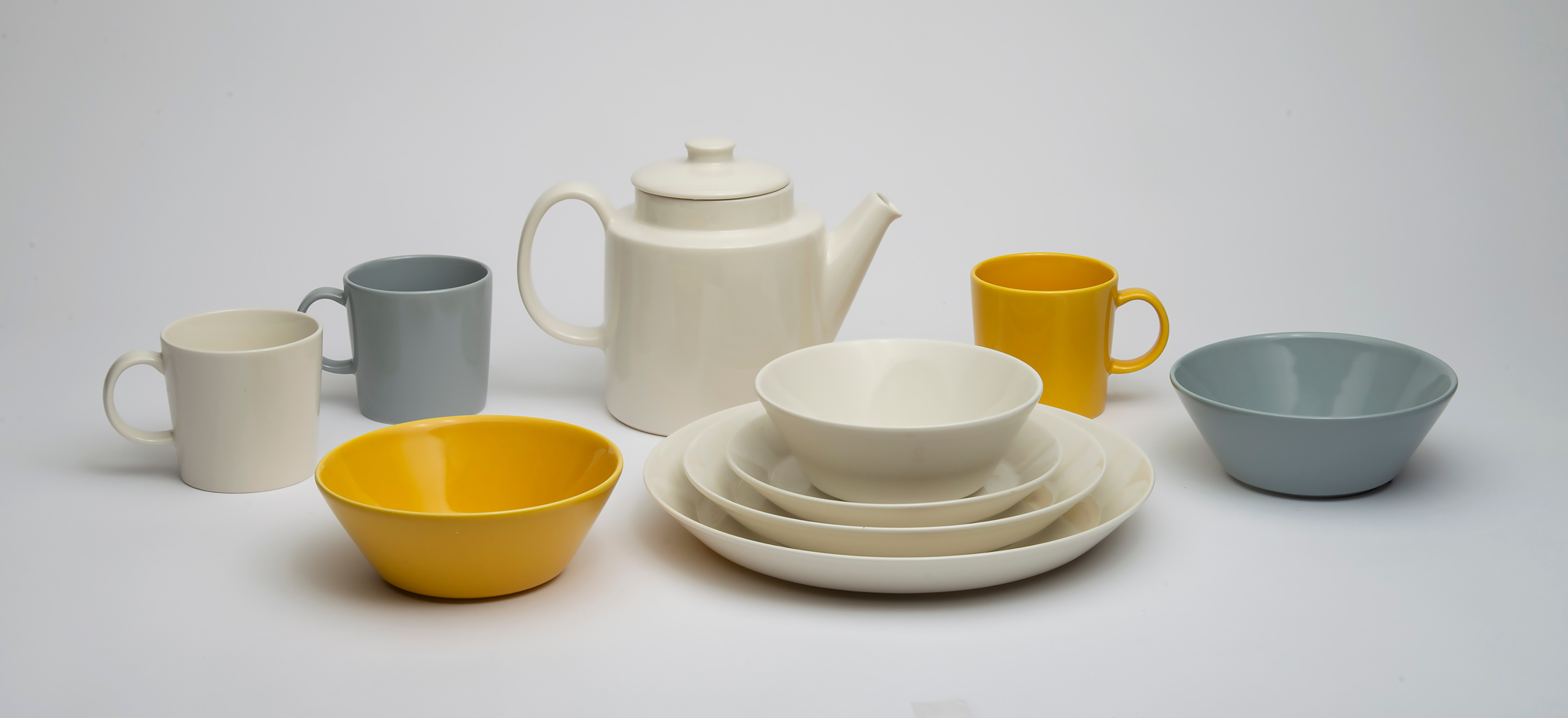 Iittala Teema items such as the white, grey and yellow mugs, bowls and plates and the white teapot.