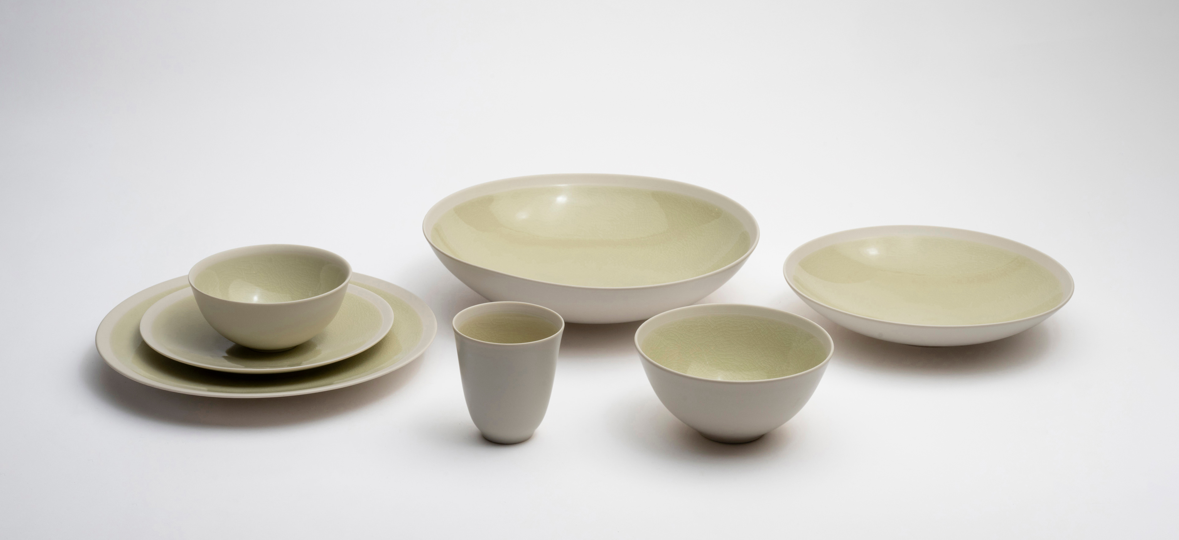 Jars Épure sage pottery on a grey background.
