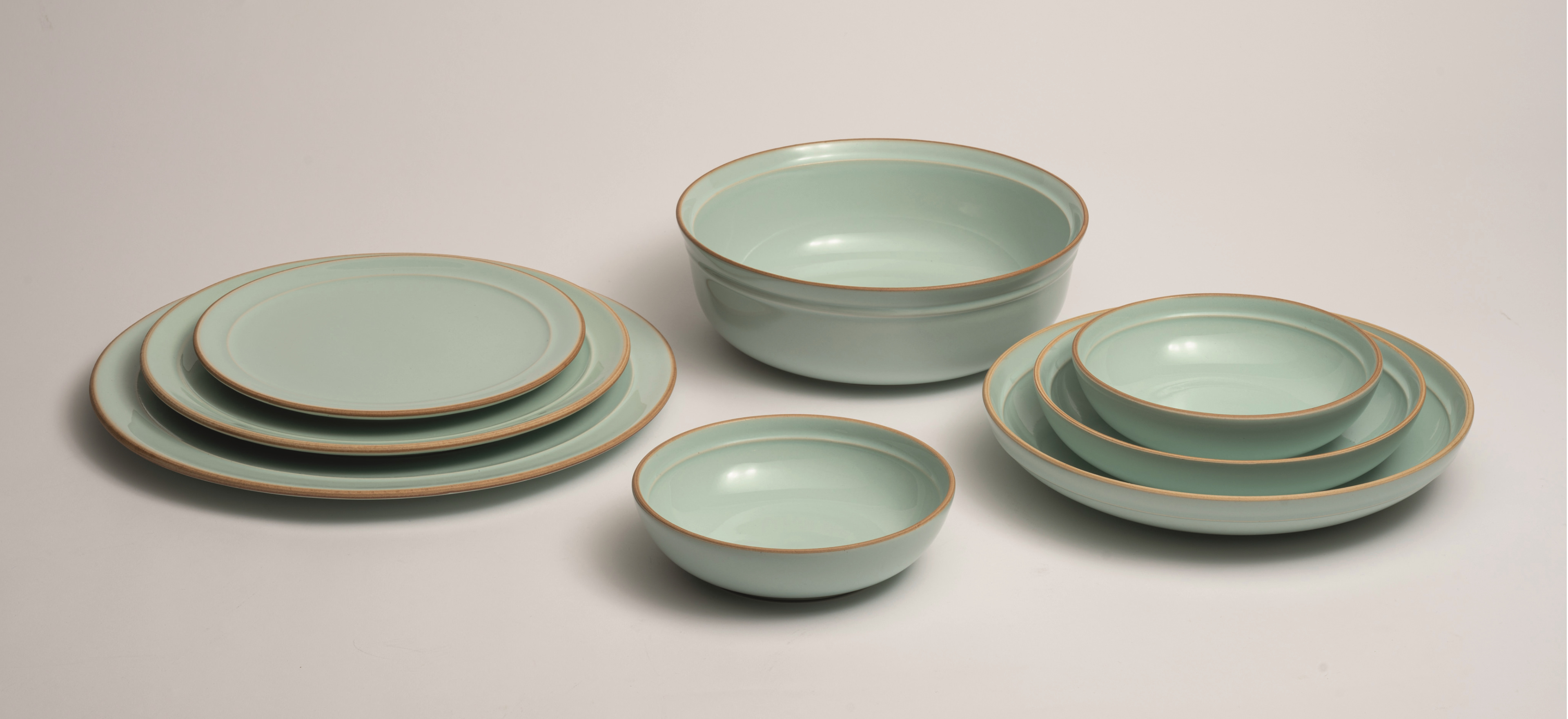 Montefeltro Menta pottery on a grey background.