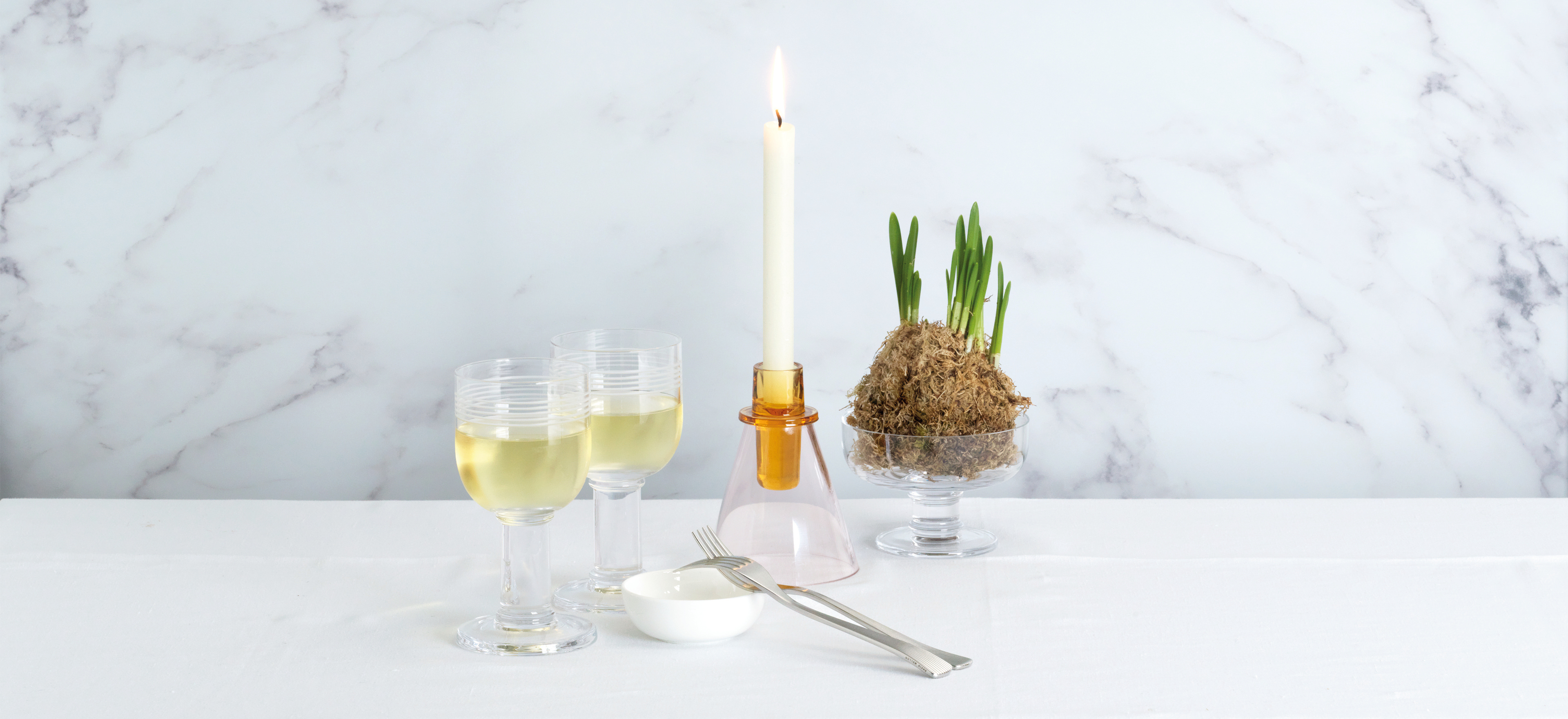 David Mellor glassware items on a marble background.