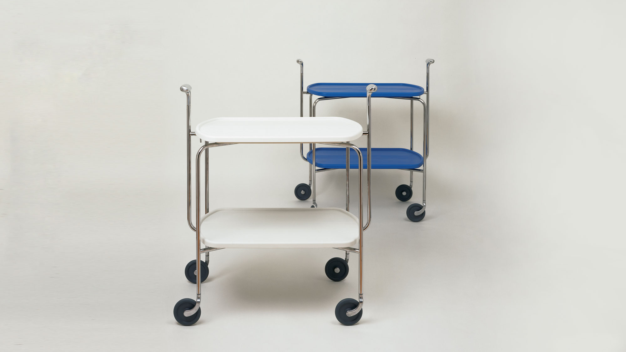 Transit folding trolley - Chromed steel with white plastic on a grey background.