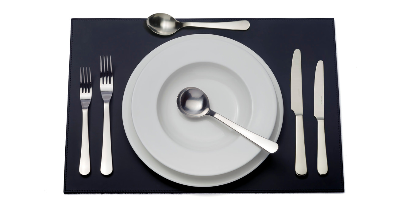 Chelsea cutlery laid out on a table mat.
