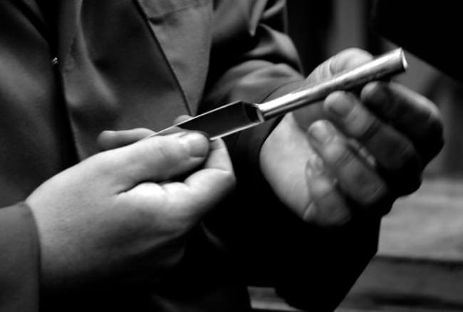 A table knife being inspected.