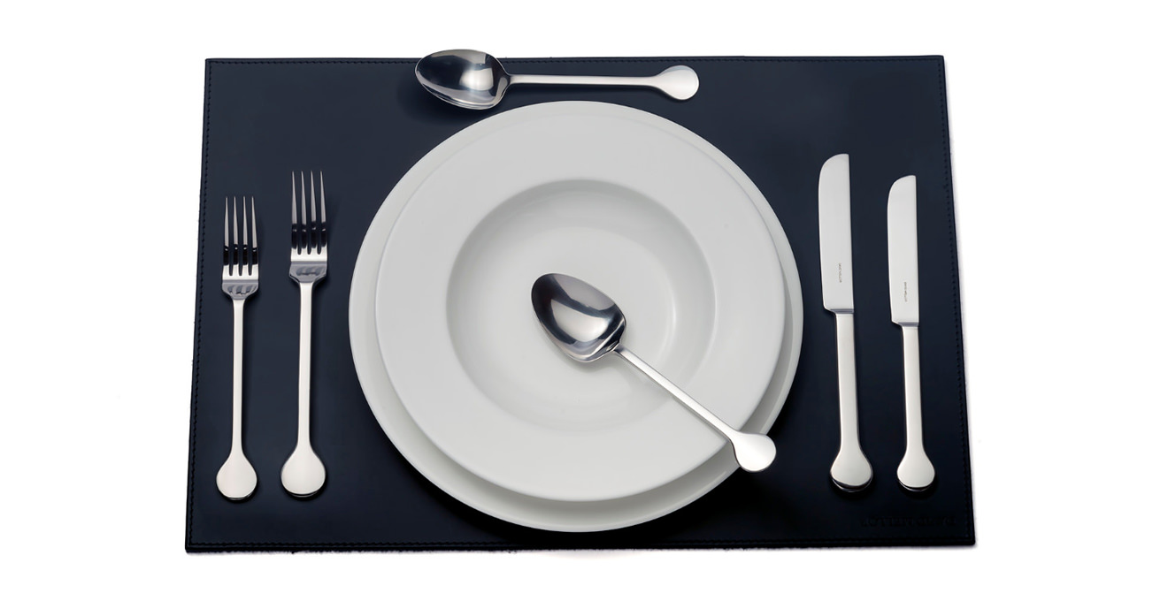Hoffmann cutlery laid out on a table mat.