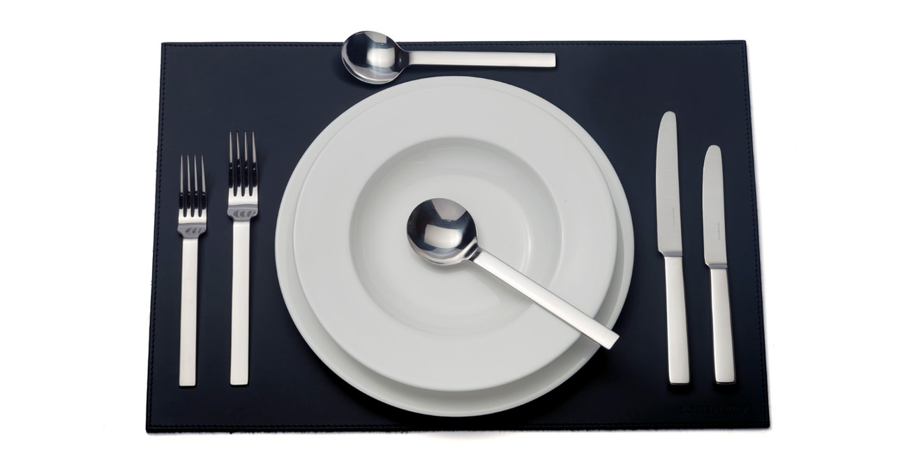 Odeon cutlery laid out on a table mat.